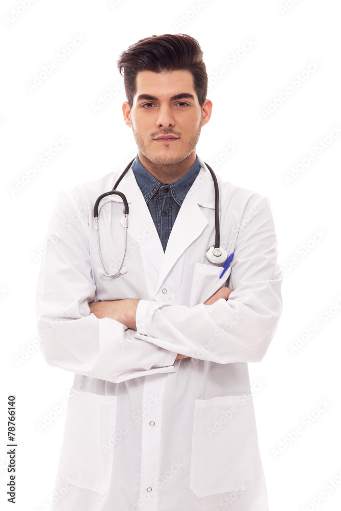 Male doctor is standing with crossed hands over white isolated b Male doctor is standing with crossed hands over white isolated b