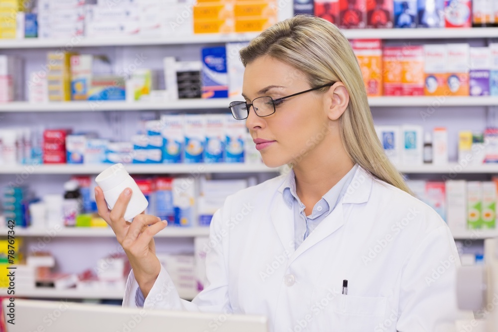 Pharmacist looking at medicine