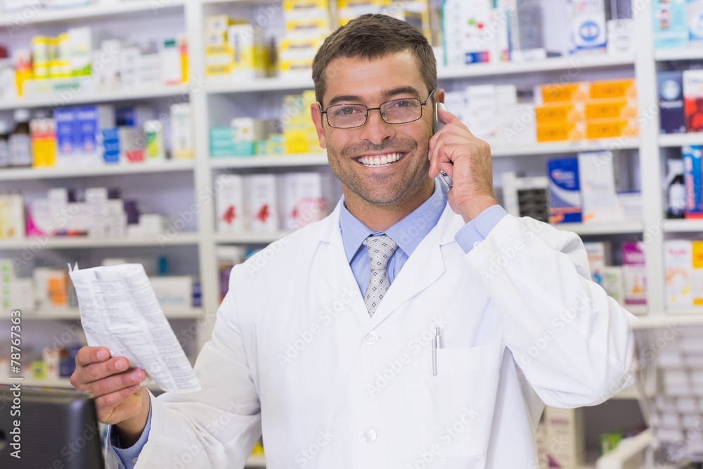 Happy pharmacist on the phone looking at the camera