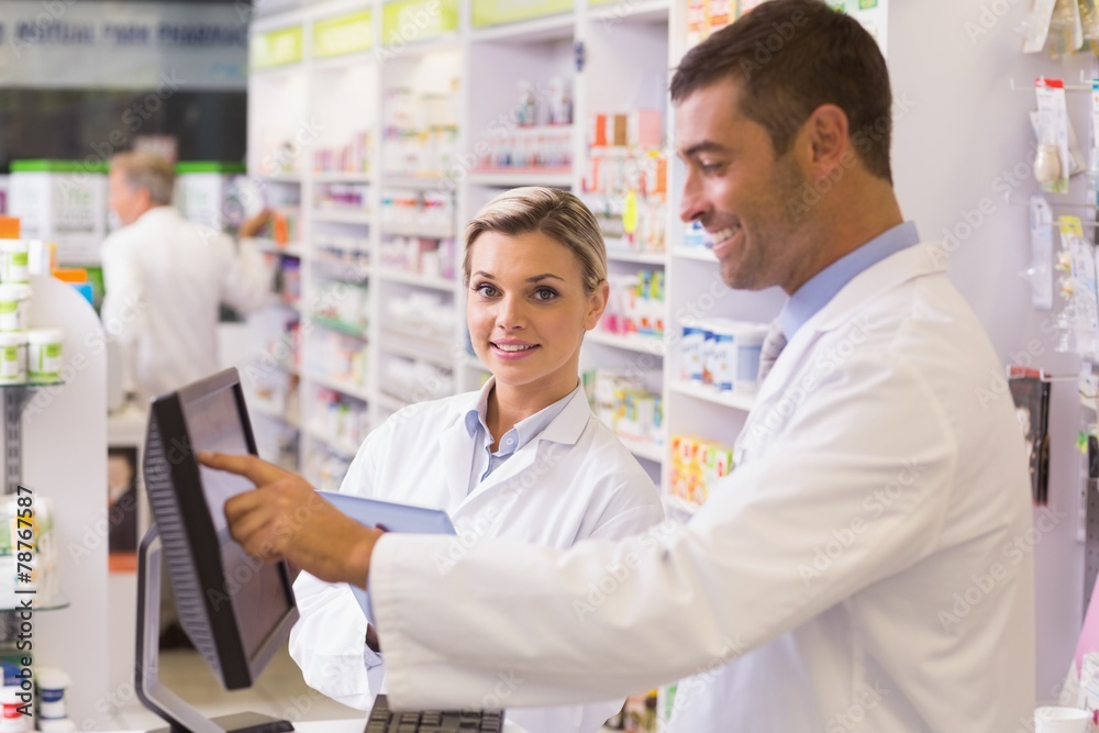 Team of pharmacists using computer