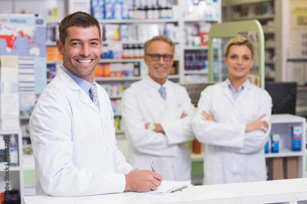 Team of pharmacists smiling at camera Team of pharmacists smiling at camera