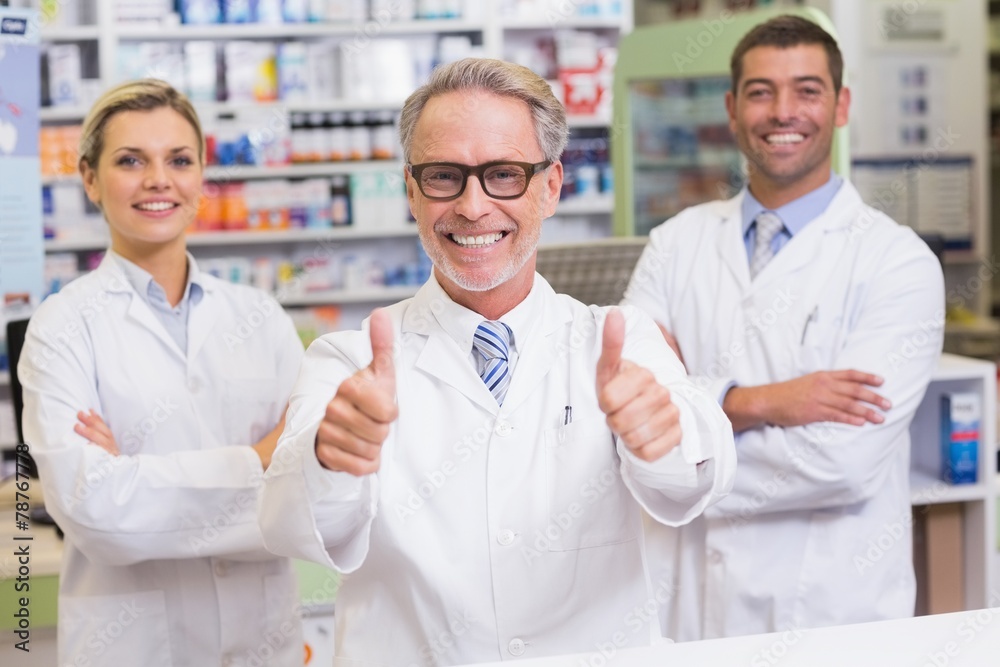 Team of pharmacists smiling at camera Team of pharmacists smiling at camera