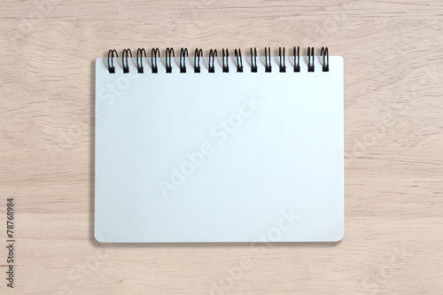 white page of notebook on wood texture