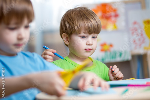 kids boys painting in nursery at home photo