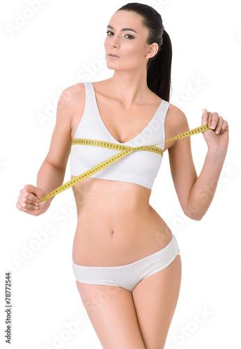 Slim woman in white underwear and measure around her leg on