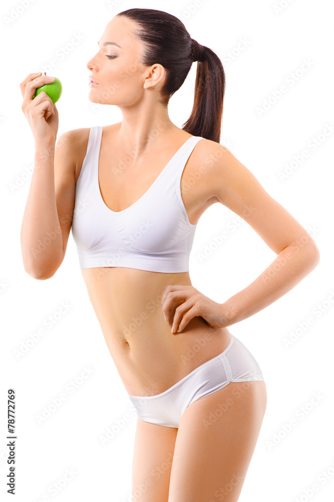 Slim woman in white underwear with green apple at her hands over Slim woman in white underwear with green apple at her hands over