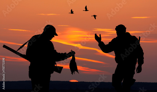 two hunters at sunset