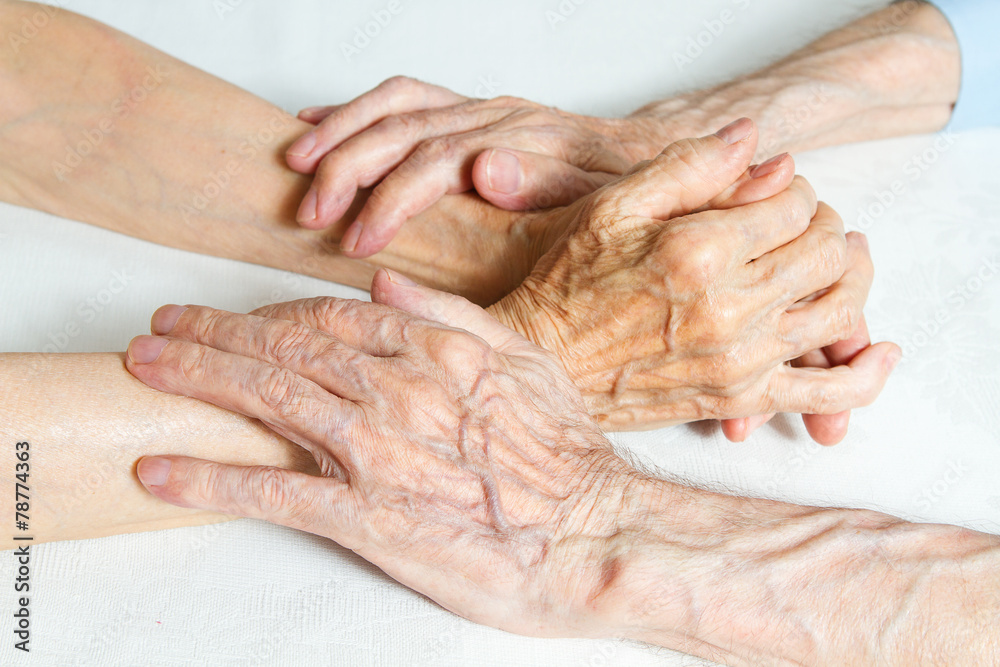 Fototapeta premium Old people holding hands. Closeup.