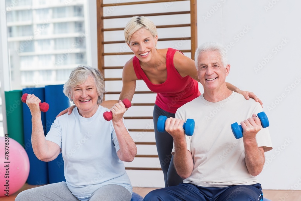 Happy female trainer with senior couple Happy female trainer with senior couple