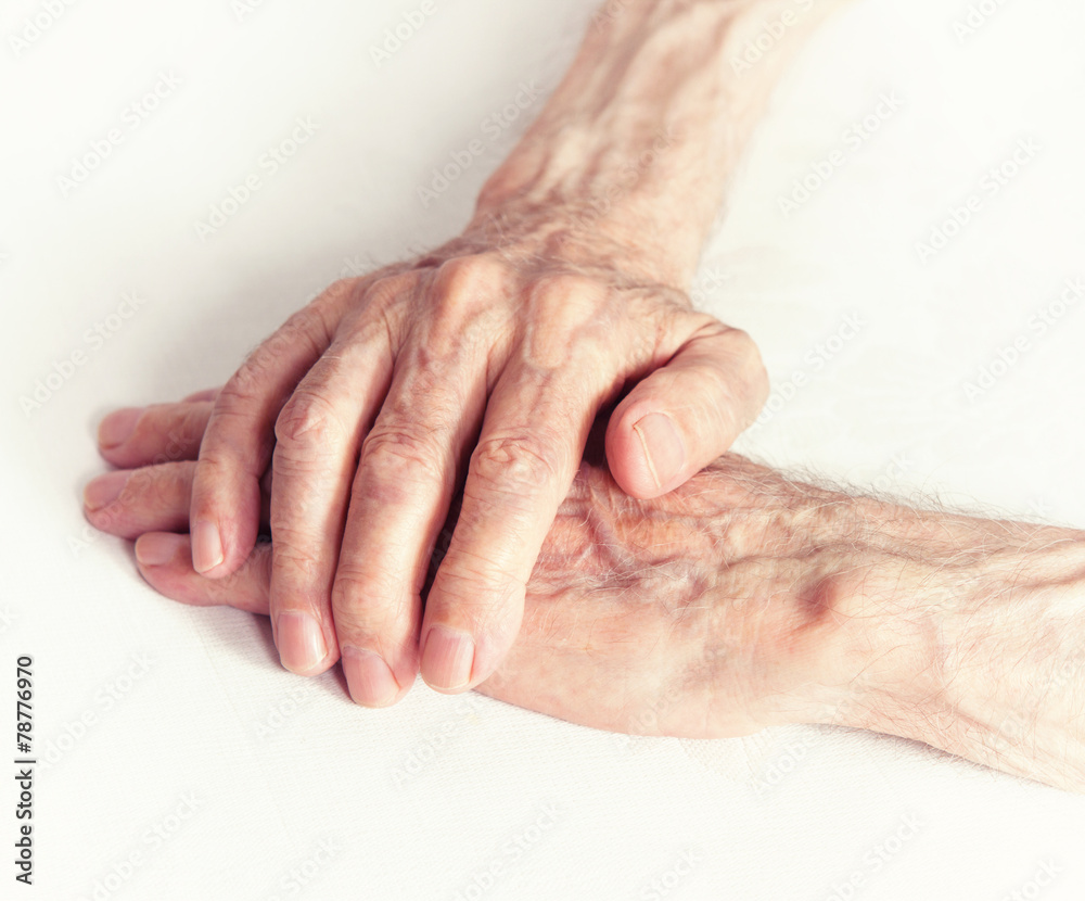 Fototapeta premium Old people holding hands. Closeup.