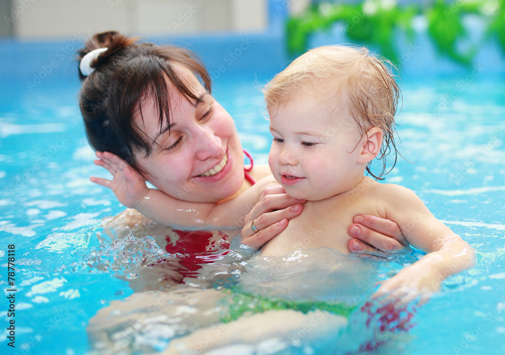 Mother play with her lovely child in swimming-pool Mother play with her lovely child in swimming-pool