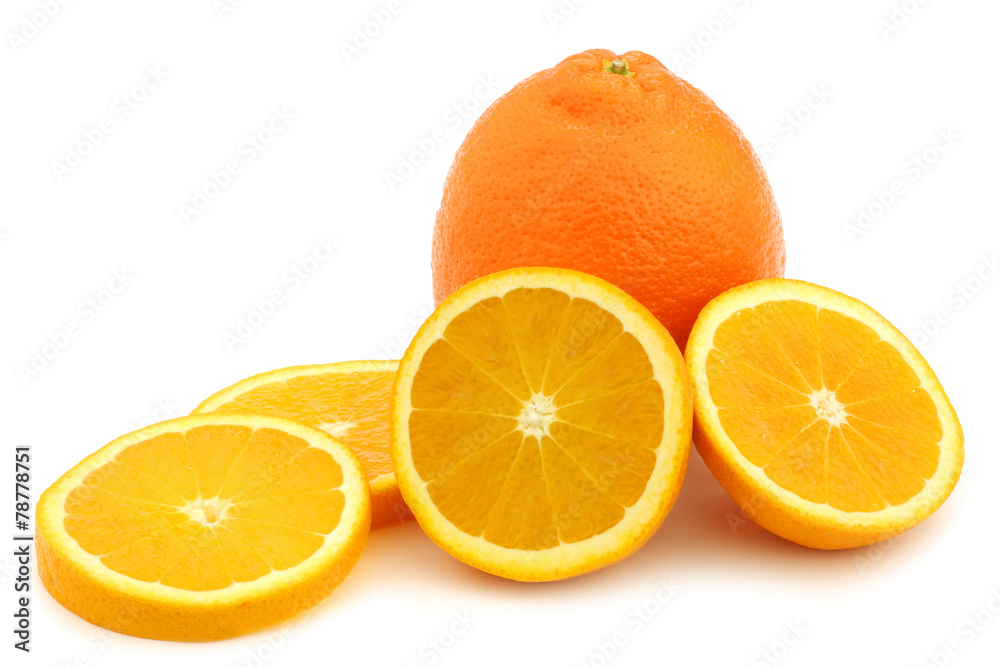 minneola fruit and a cut one in slices on a white background