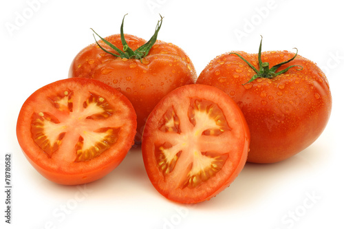 fresh beef tomatoes and a cut one on a white background