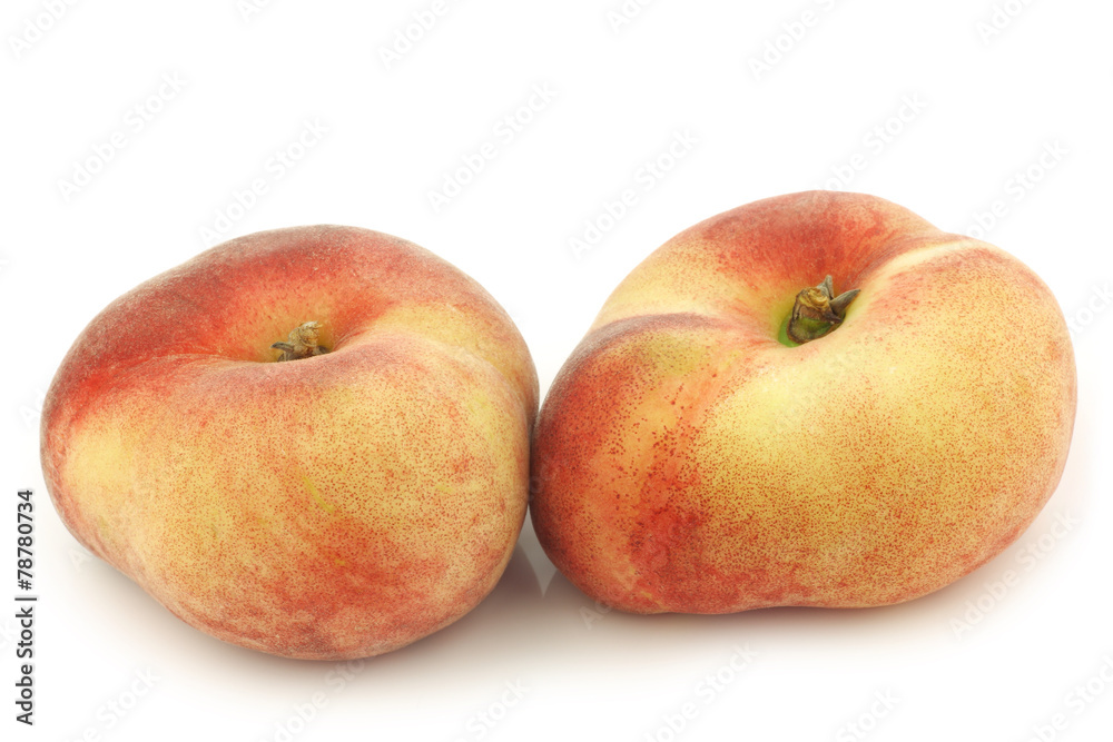 Fresh wild (flat) nectarines on a white background Fresh wild (flat) nectarines on a white background
