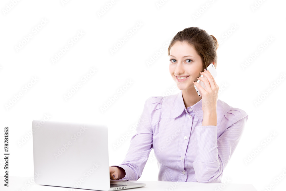 Young girl taking business call in front of laptop Young girl taking business call in front of laptop