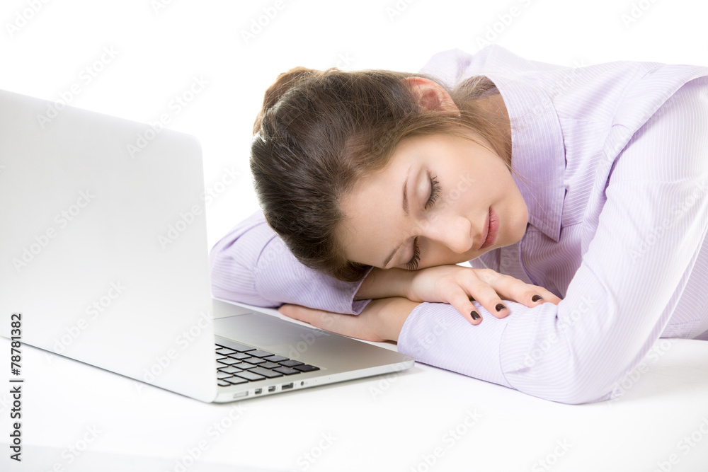 Overworked young woman sleeping in front of laptop Overworked young woman sleeping in front of laptop