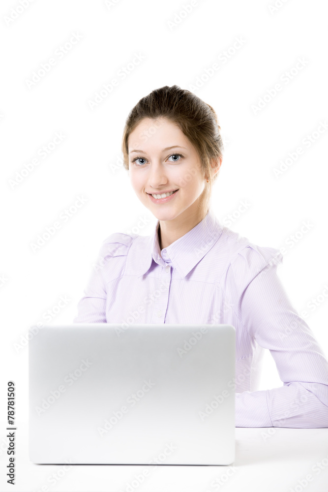 Young smiling girl sitting in front of laptop Young smiling girl sitting in front of laptop