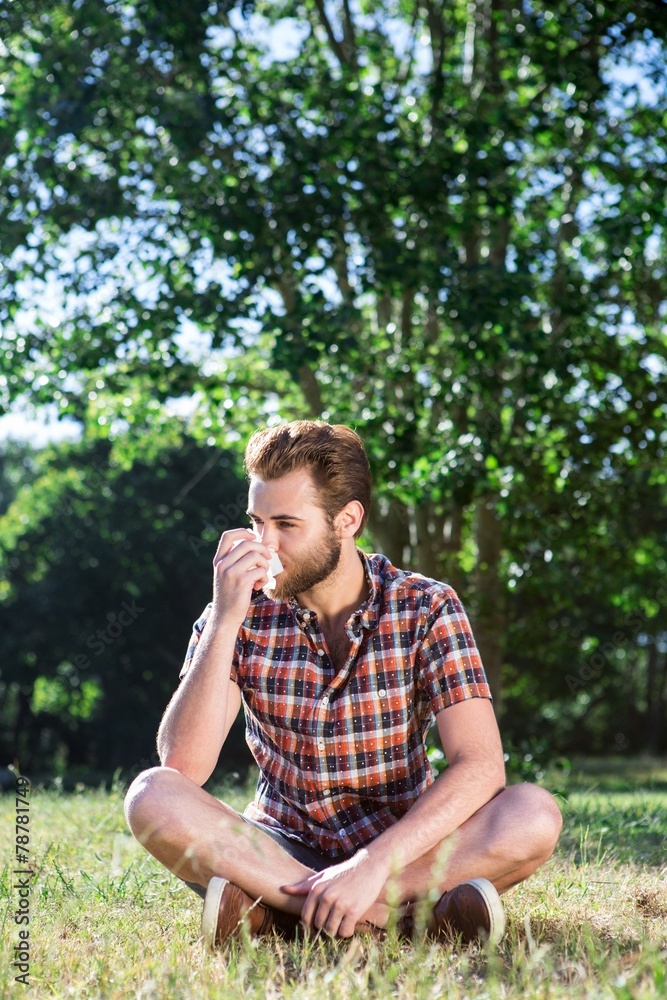 Handsome hipster blowing his nose Handsome hipster blowing his nose