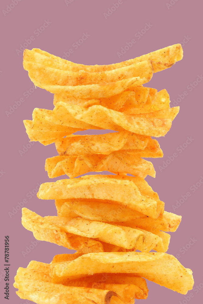 deep ridged potato chips on a purple background deep ridged potato chips on a purple background