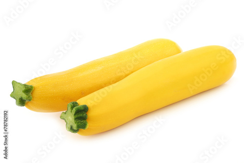 two yellow zucchini's on a white background