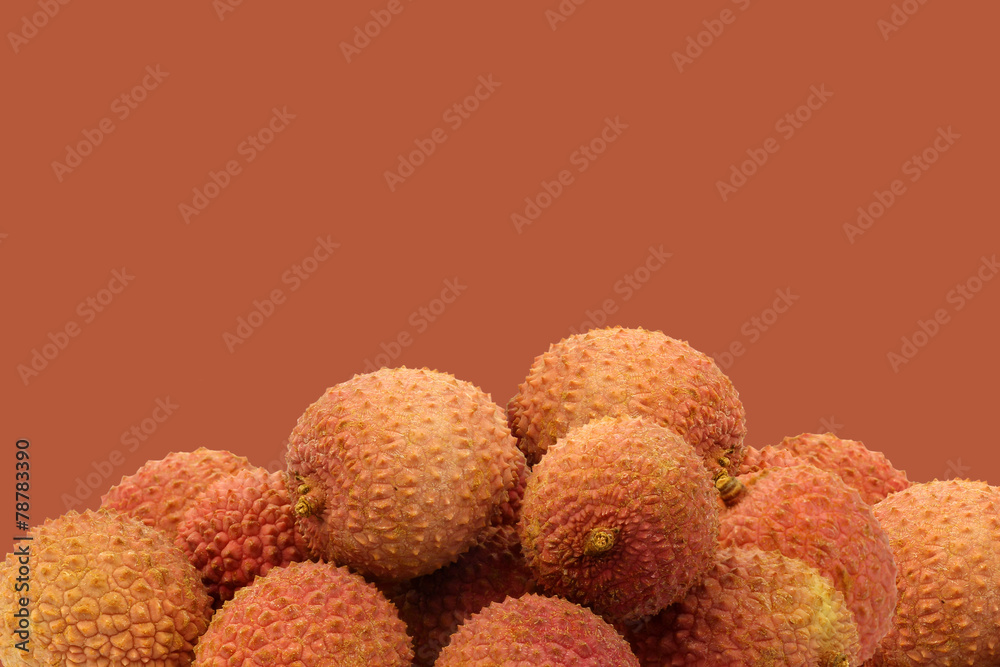 fresh lychees on a brown background