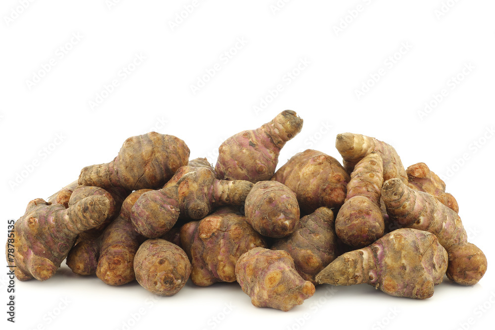 bunch of topinambur roots (helianthus tuberosus) on a white back bunch of topinambur roots (helianthus tuberosus) on a white back