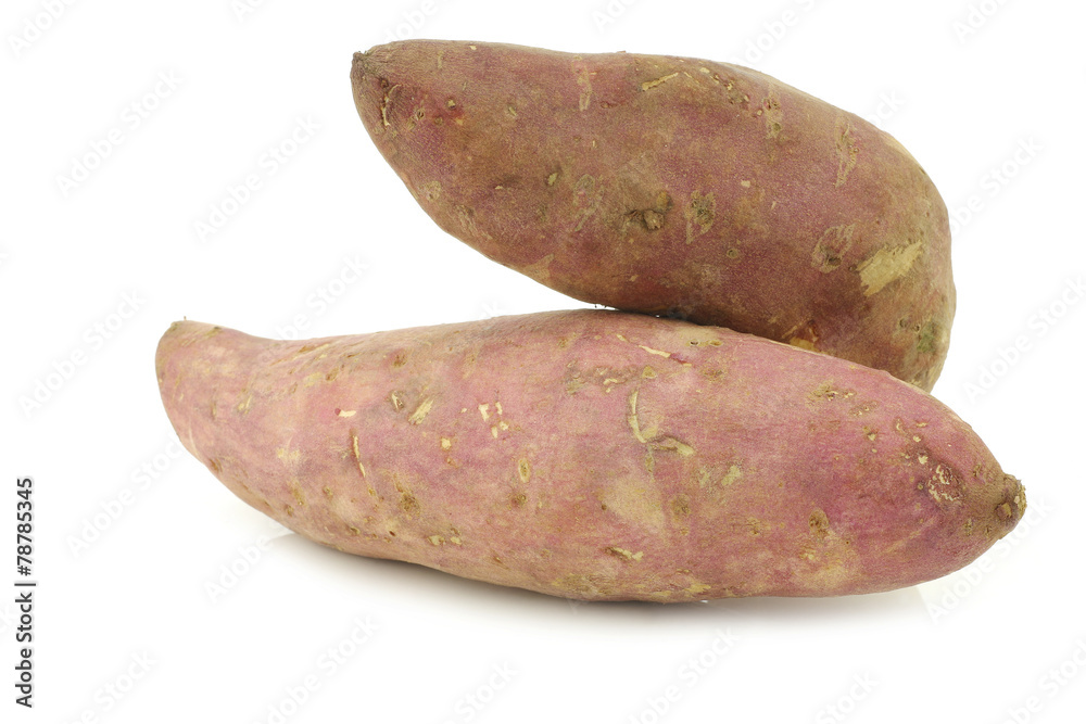 two whole sweet potatoes on a white background two whole sweet potatoes on a white background