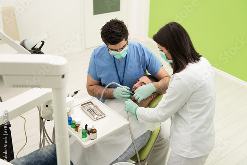 Young Man Having His Teeth Dental Care