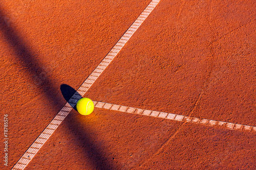 Tennis ball on a tennis court © Kavita