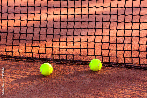 Tennis ball on a tennis clay court © Kavita