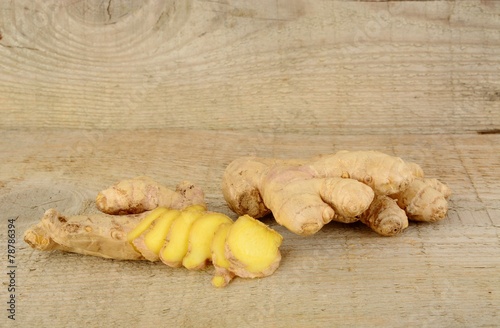 Studio shot of sliced ginger isolated on wooden table