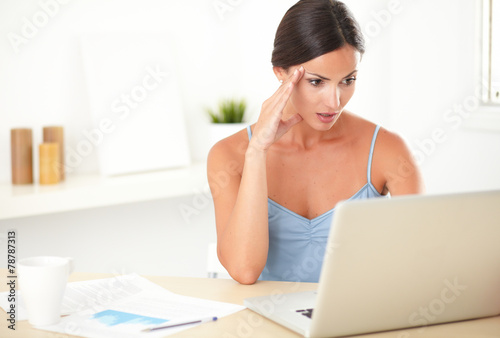 Stressed adult woman working on her computer