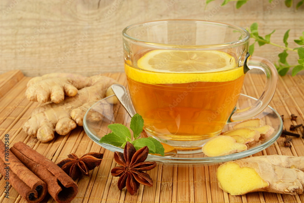 Ginger tea-ingwertee on wooden mat with lemon Ginger tea-ingwertee on wooden mat with lemon