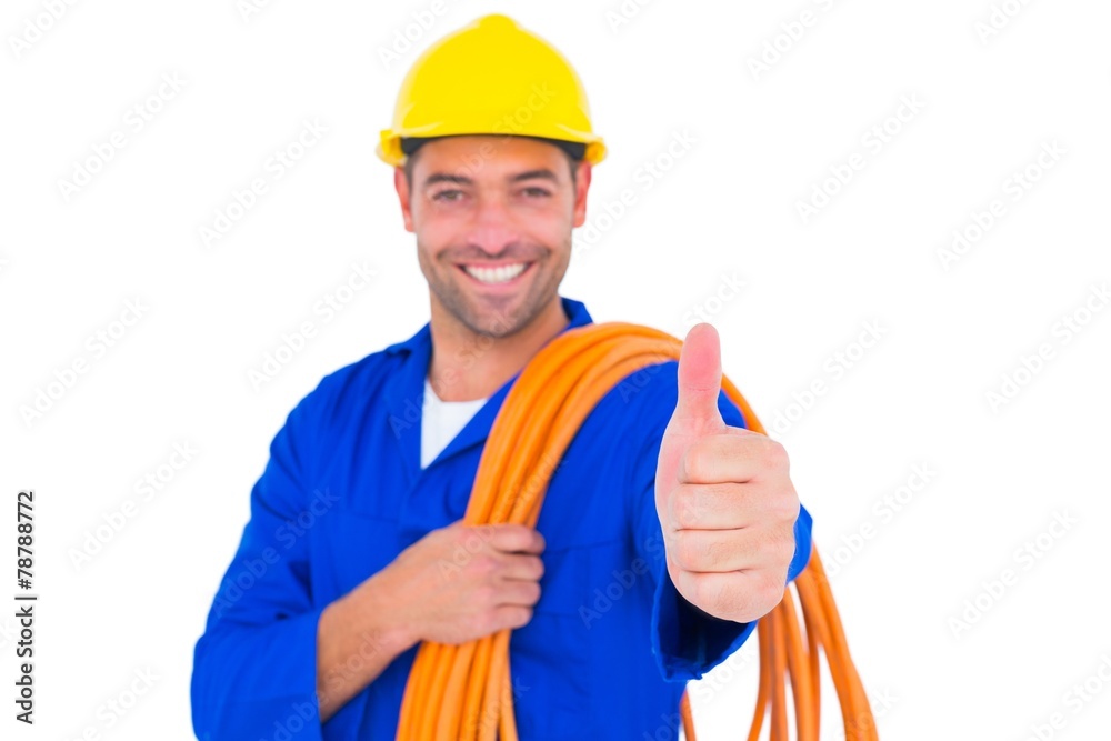 Electrician with rolled wire gesturing thumbs up