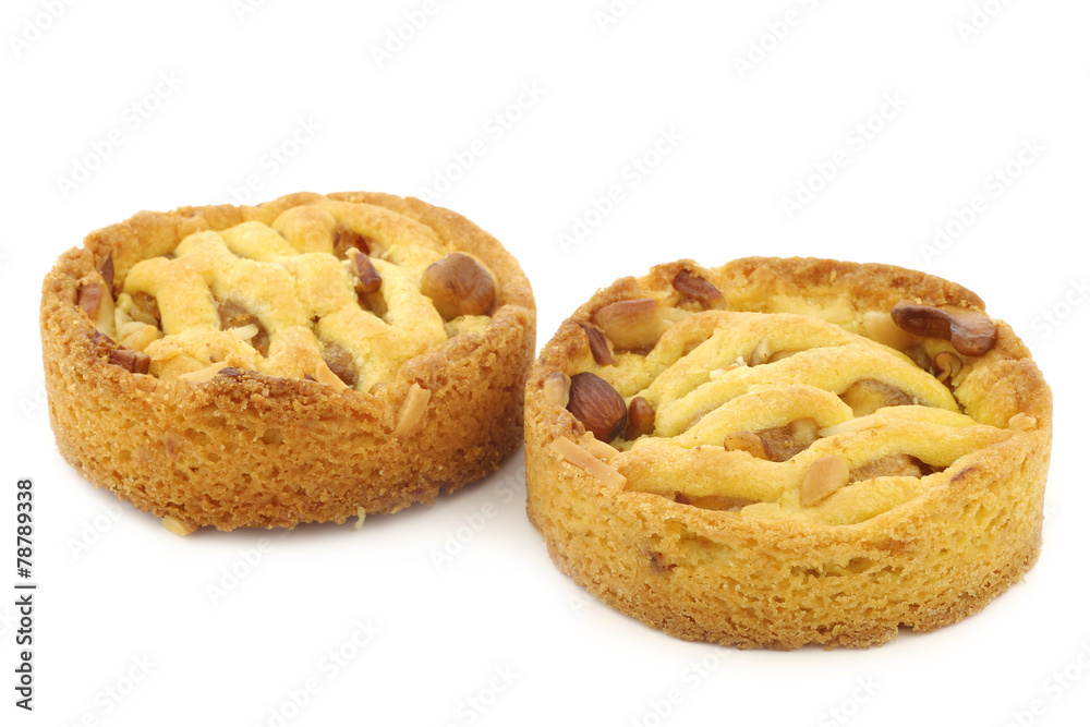 freshly baked apple and nuts cake and a cut piece on a white bac freshly baked apple and nuts cake and a cut piece on a white bac