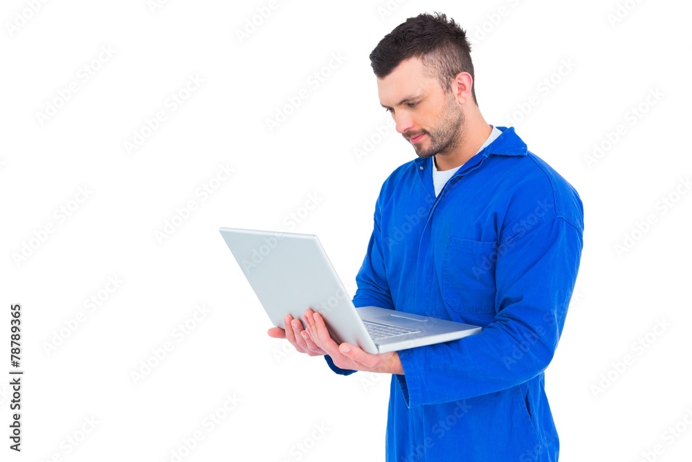 Happy mechanic using laptop Happy mechanic using laptop