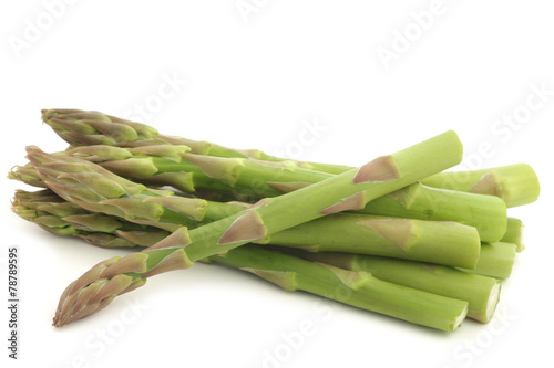  fresh green asparagus tips on a white background