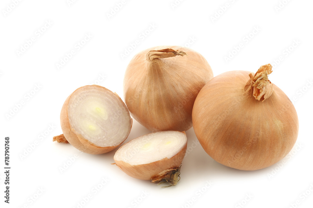 Fototapeta premium two shallots and a cut one on a white background