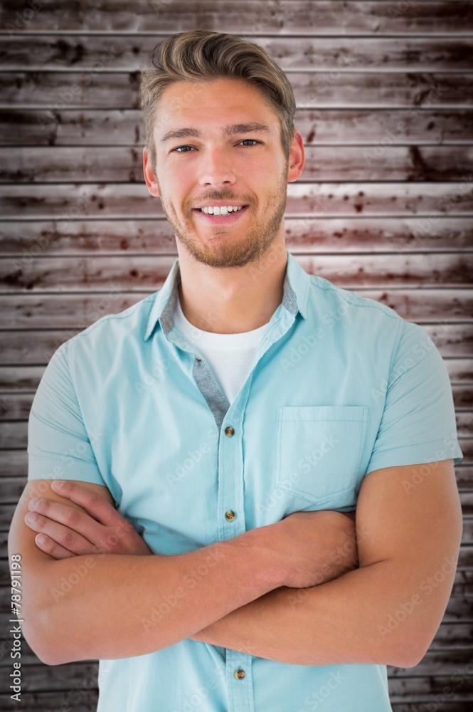 Composite image of handsome young man posing with arms crossed Composite image of handsome young man posing with arms crossed