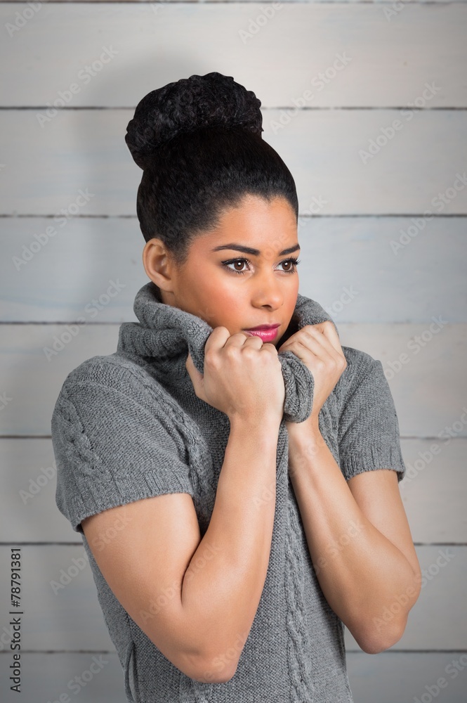 Composite image of pretty girl in winter jumper shivering Composite image of pretty girl in winter jumper shivering