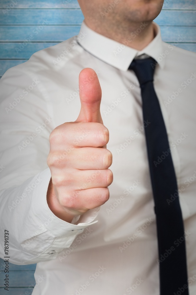 Composite image of businessman giving thumbs up to camera Composite image of businessman giving thumbs up to camera