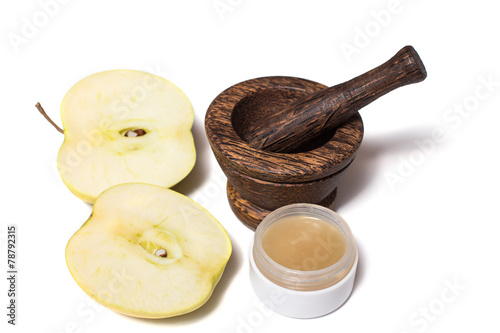 Wooden pounder with bottles of organic cream isolated