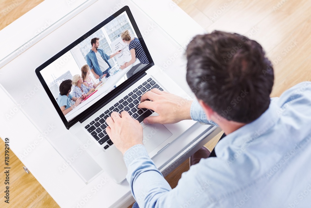 Composite image of high angle view of casual man using laptop Composite image of high angle view of casual man using laptop