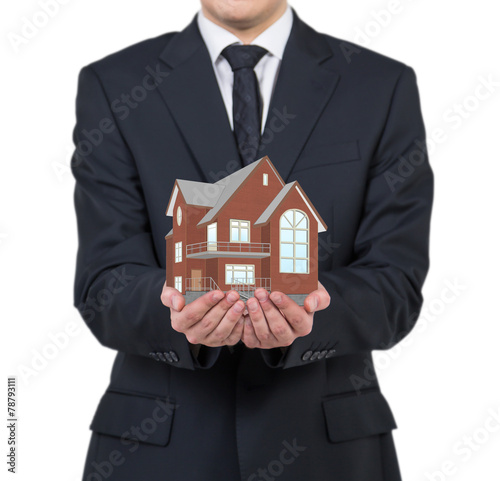 businessman holding house