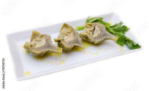 Boiled artichokes on tray on white background