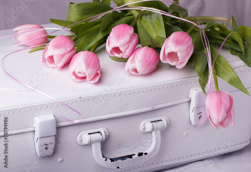 Fototapeta Naklejka Na Ścianę i Meble -  Pink tulips, white vintage suitcases.
