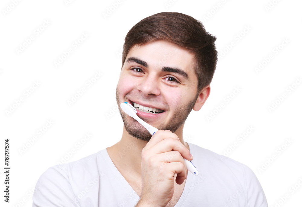 Portrait of young man with toothbrush in hand isolated on white Portrait of young man with toothbrush in hand isolated on white