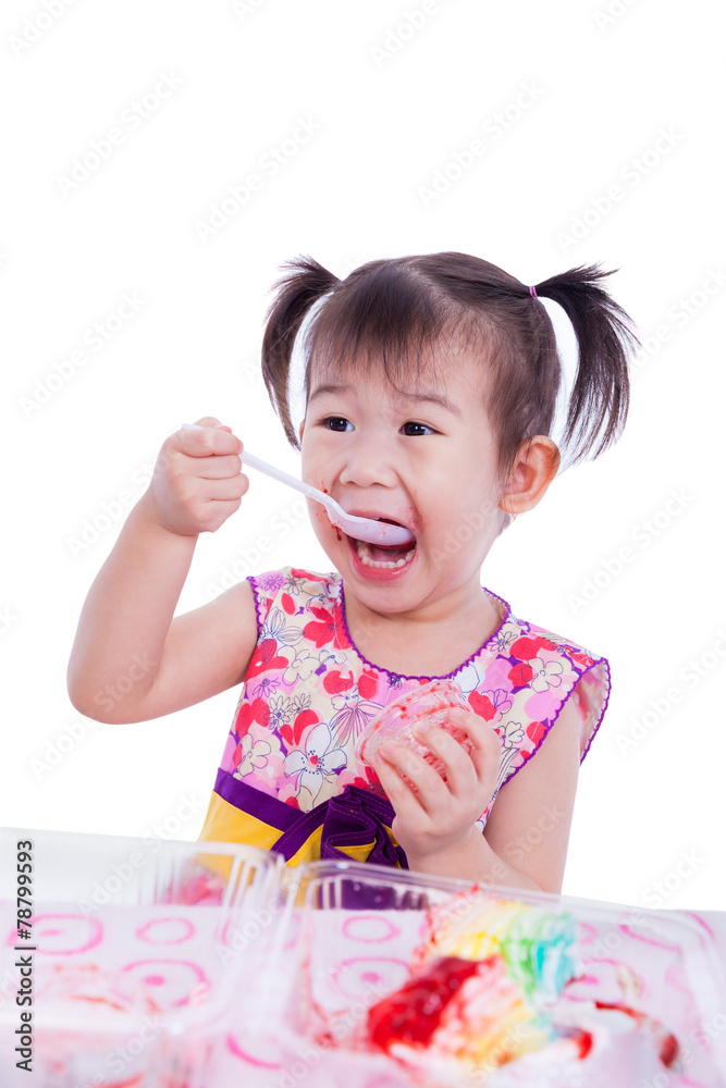 Little asian (thai) girl enjoy eating her birthday cake Little asian (thai) girl enjoy eating her birthday cake