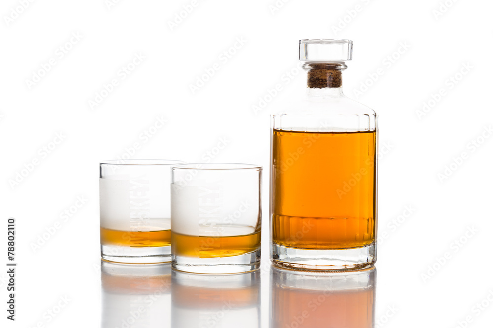 Two whiskey on neat, with a whiskey bottle Two whiskey on neat, with a whiskey bottle