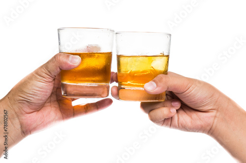 Two hands toasting whiskey on the rock with white background